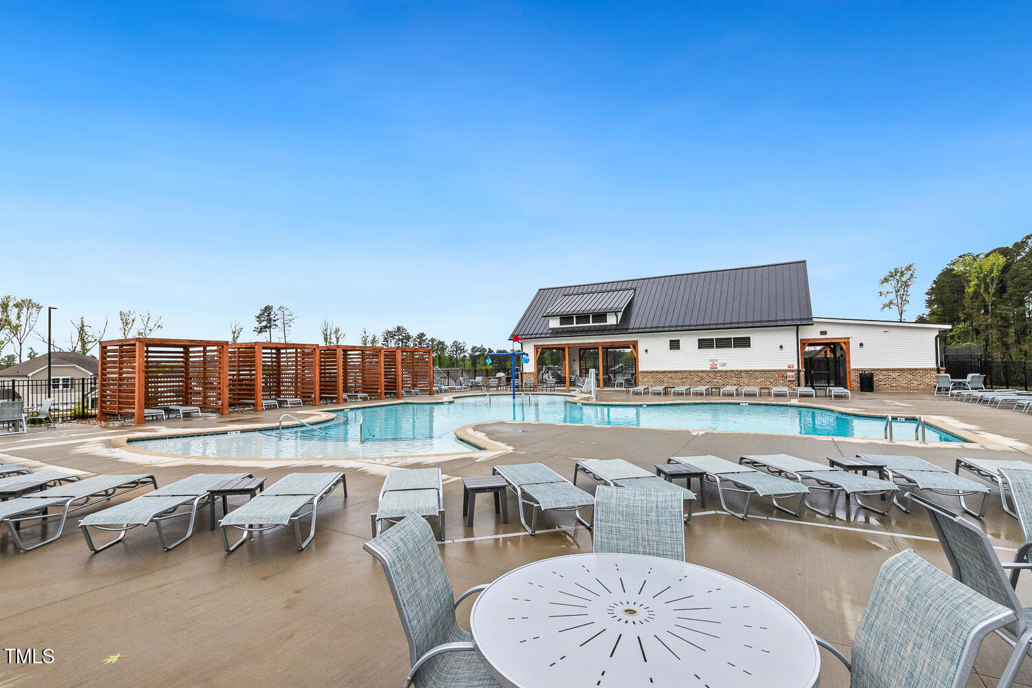 1116 Ciandra Barn Way Apex, NC 27523 - Photo 56 of 59 a view of a swimming pool with outdoor seating and a garden