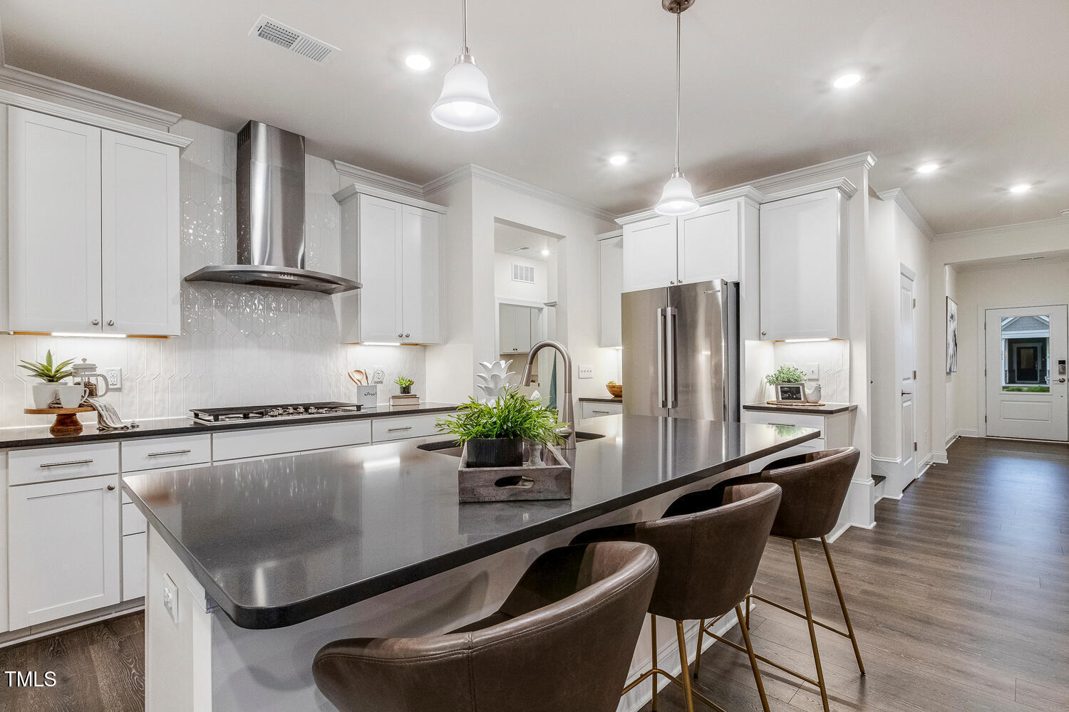1116 Ciandra Barn Way Apex, NC 27523 - Photo 6 of 59 a kitchen with stainless steel appliances granite countertop a refrigerator a sink dishwasher a stove and white cabinets with wooden floor