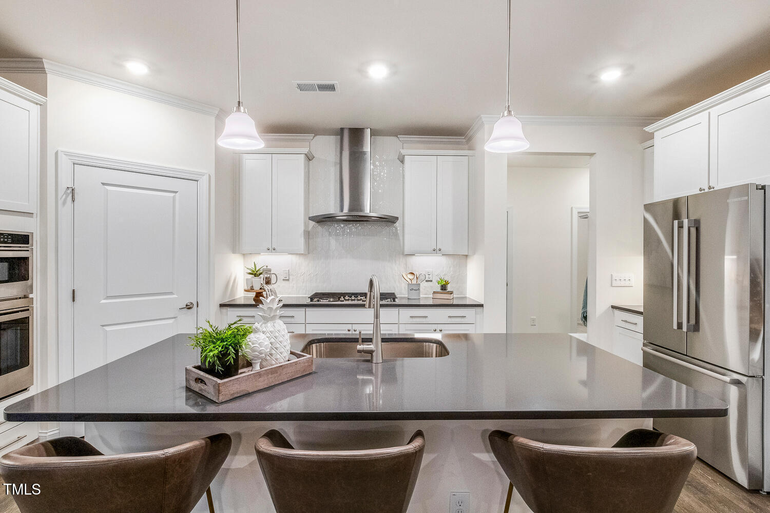 1116 Ciandra Barn Way Apex, NC 27523 - Photo 9 of 59 a kitchen with stainless steel appliances granite countertop a dining table chairs refrigerator and microwave