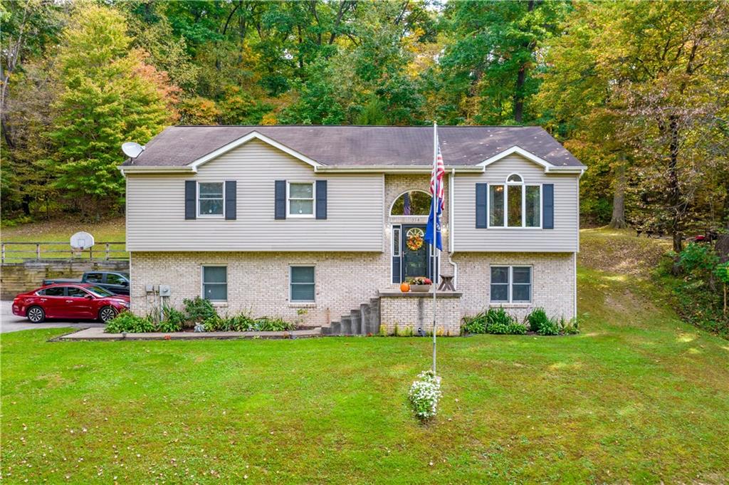 a front view of house with yard and green space