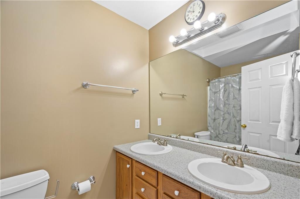 314 Glade Run Road Renfrew, PA 16053 - Photo 11 of 24 a bathroom with a granite countertop sink a toilet and a mirror