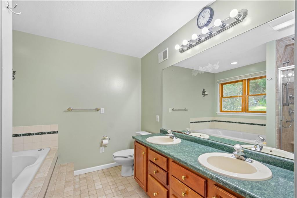 314 Glade Run Road Renfrew, PA 16053 - Photo 15 of 24 a bathroom with a granite countertop double vanity sink a mirror and a toilet