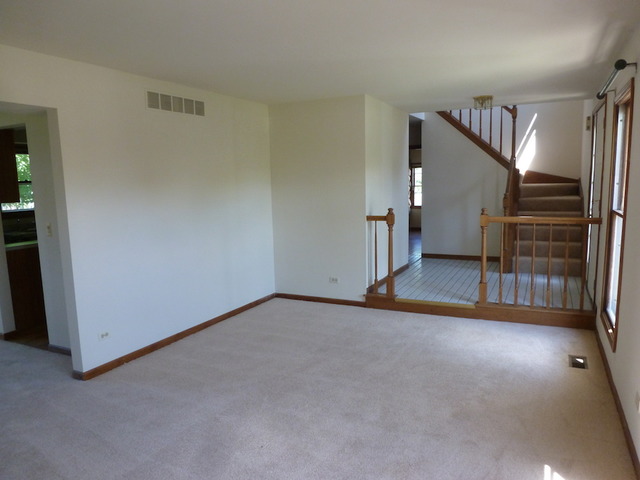 107 Country Court Bolingbrook, IL 60440 - Photo 2 of 13 an empty room with staircase and windows