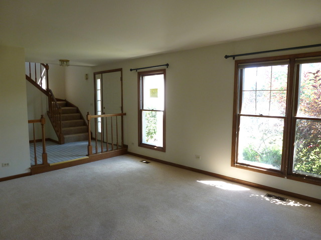 107 Country Court Bolingbrook, IL 60440 - Photo 3 of 13 an empty room with windows and stairs