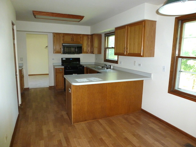 107 Country Court Bolingbrook, IL 60440 - Photo 6 of 13 a kitchen with stainless steel appliances granite countertop a stove a sink and a refrigerator