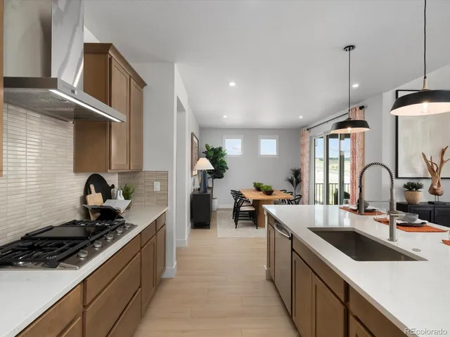 a kitchen with a sink stove and cabinets