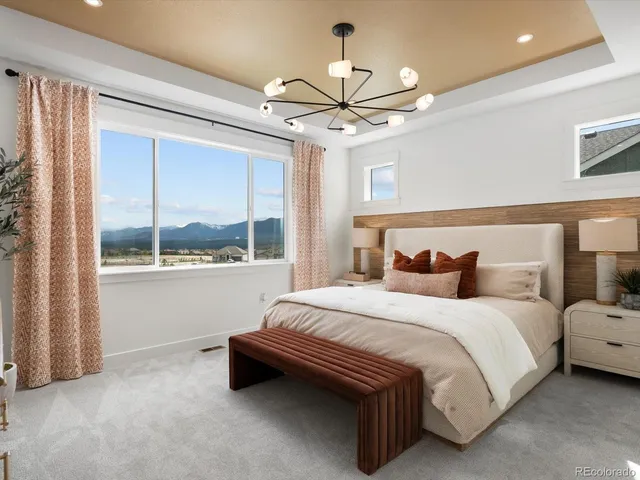 a spacious bedroom with a bed and a large window