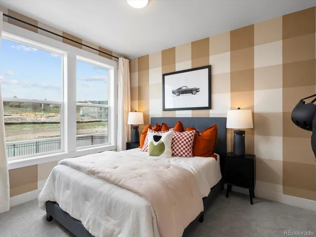 a large bed sitting in a bedroom next to a window