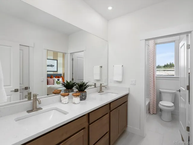 a bathroom with a sink double vanity and a toilet