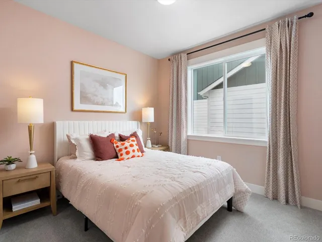 a bedroom with a bed and a night stand