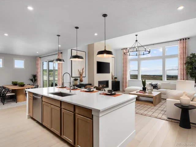a kitchen that has a lot of cabinets a sink and a stove in it