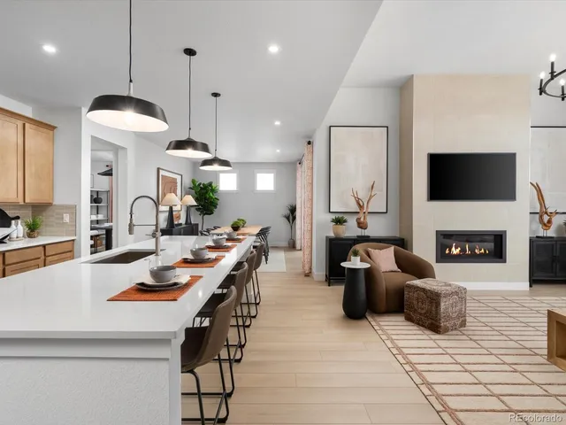 a kitchen with sink a stove and chairs