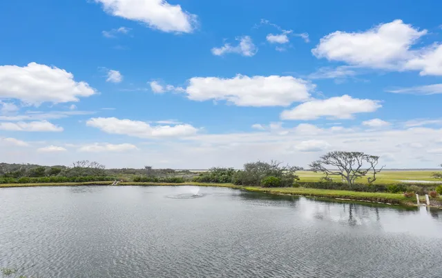 a view of a lake with green space