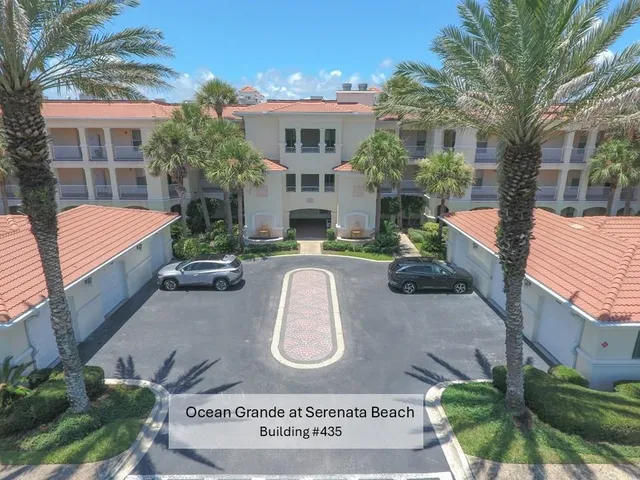 front view of house with a yard and potted plants