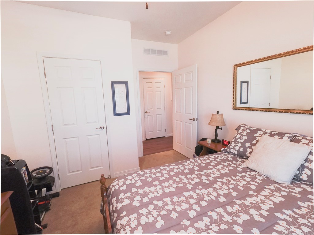 1051 Site Drive, Unit 286 Brea, CA 92821 - Photo 19 of 25 a bedroom with a bed and a dresser