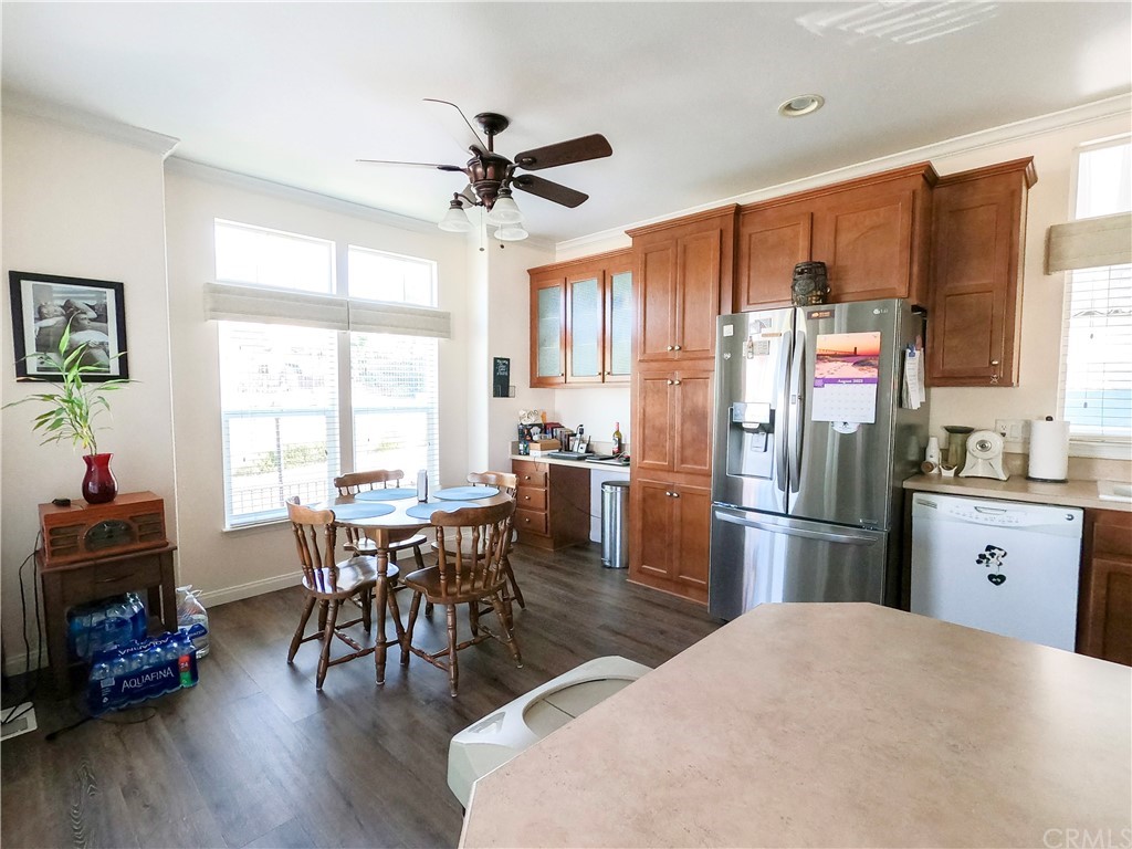 1051 Site Drive, Unit 286 Brea, CA 92821 - Photo 7 of 25 a kitchen with stainless steel appliances a dining table chairs refrigerator and sink
