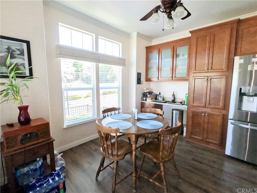 1051 Site Drive, Unit 286 Brea, CA 92821 - Photo 8 of 25 a dining room with stainless steel appliances granite countertop a stove a refrigerator a dining table and chairs with wooden floor