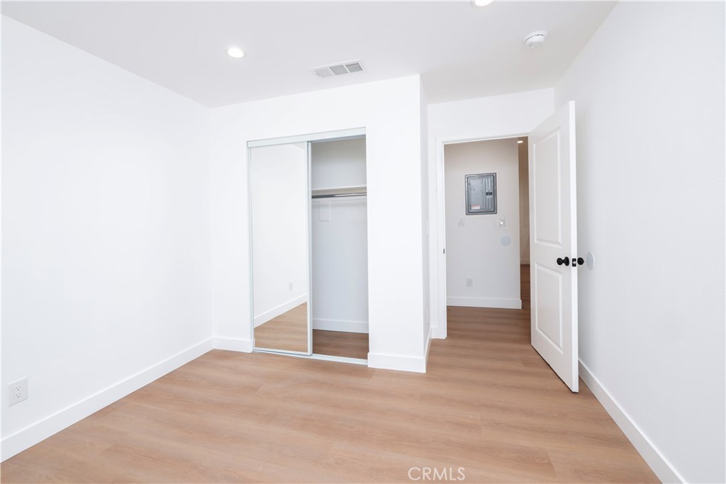 5741 South St Andrews Place, Unit 1/2 Los Angeles, CA 90062 - Photo 12 of 28 a view of an empty room with wooden floor