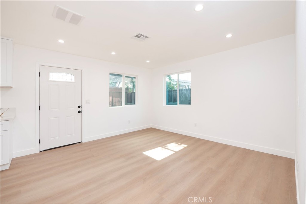 5741 South St Andrews Place, Unit 1/2 Los Angeles, CA 90062 - Photo 19 of 28 an empty room with windows