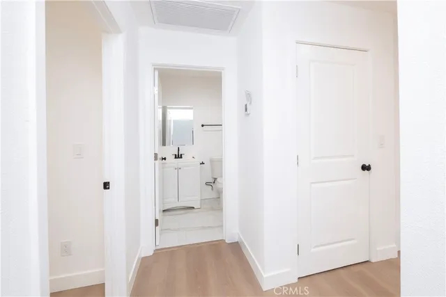 a view of a bathroom from a hallway