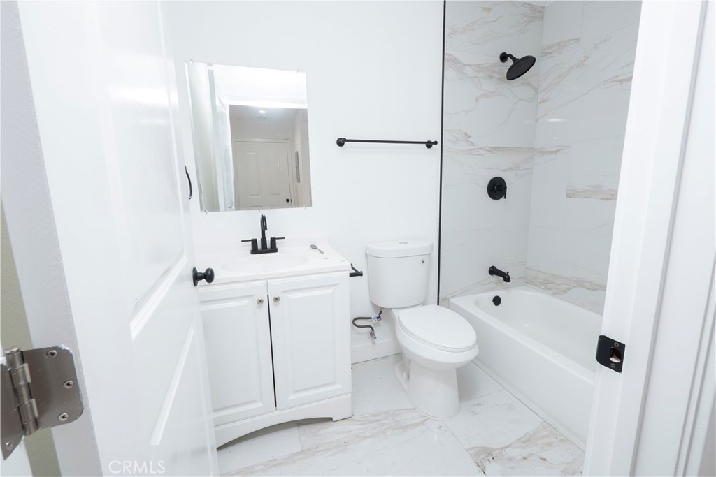 5741 South St Andrews Place, Unit 1/2 Los Angeles, CA 90062 - Photo 21 of 28 a bathroom with a sink toilet and shower