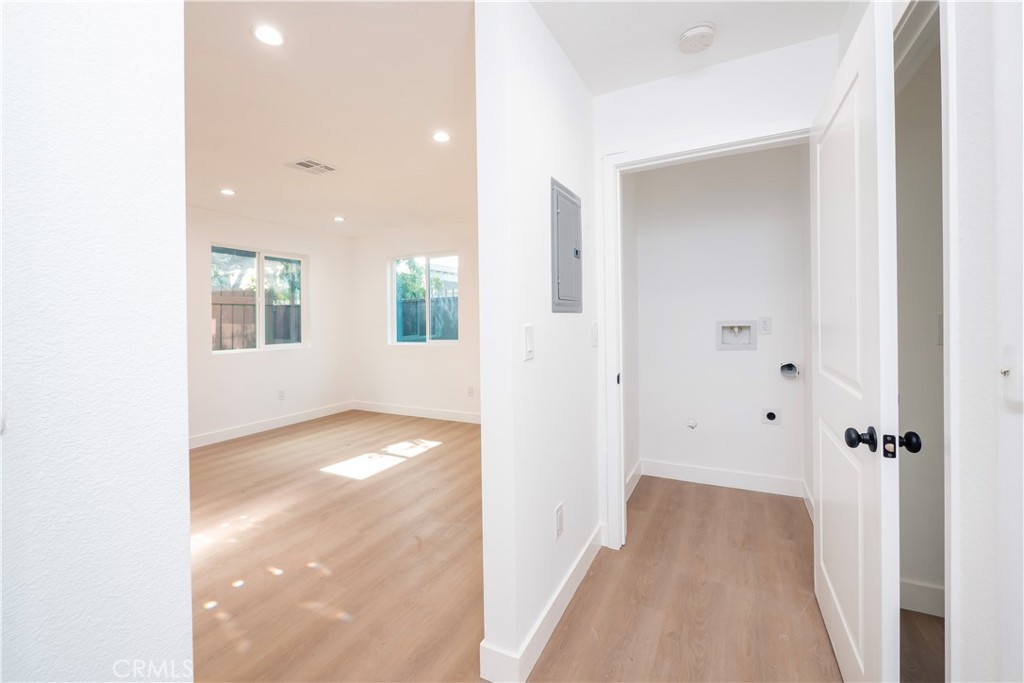 5741 South St Andrews Place, Unit 1/2 Los Angeles, CA 90062 - Photo 26 of 28 a view of a hallway with wooden floor and a bathroom