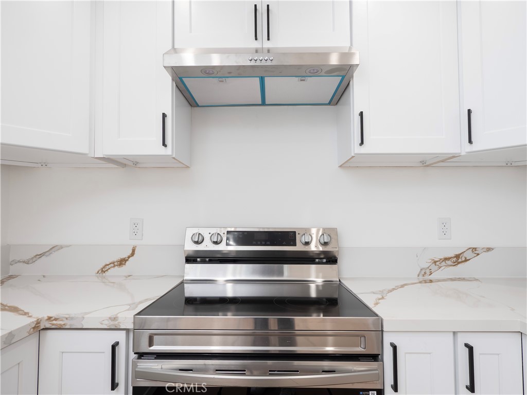 5741 South St Andrews Place, Unit 1/2 Los Angeles, CA 90062 - Photo 6 of 28 a kitchen with a sink and cabinets