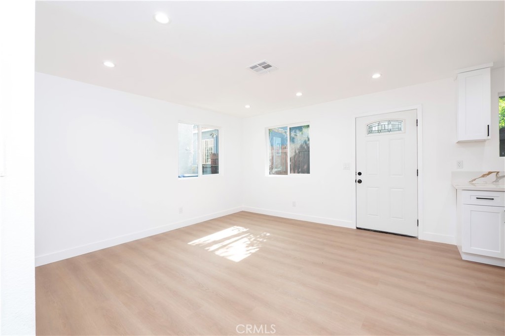 5741 South St Andrews Place, Unit 1/2 Los Angeles, CA 90062 - Photo 7 of 28 a view of empty room with wooden floor and window