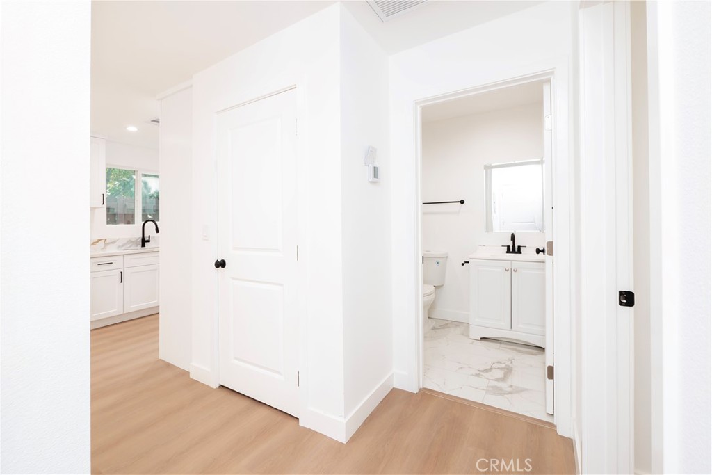 5741 South St Andrews Place, Unit 1/2 Los Angeles, CA 90062 - Photo 8 of 28 a view of a bathroom with a sink and mirror