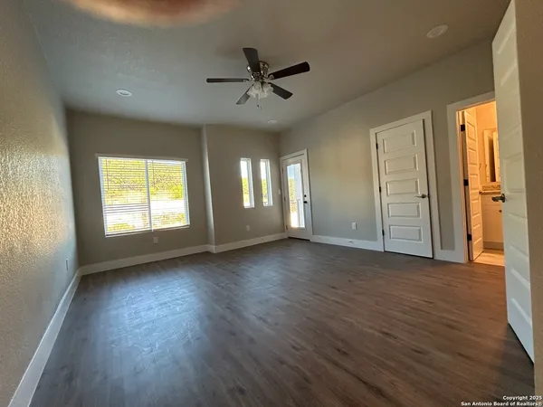 a view of a livingroom with wooden floor and a window
