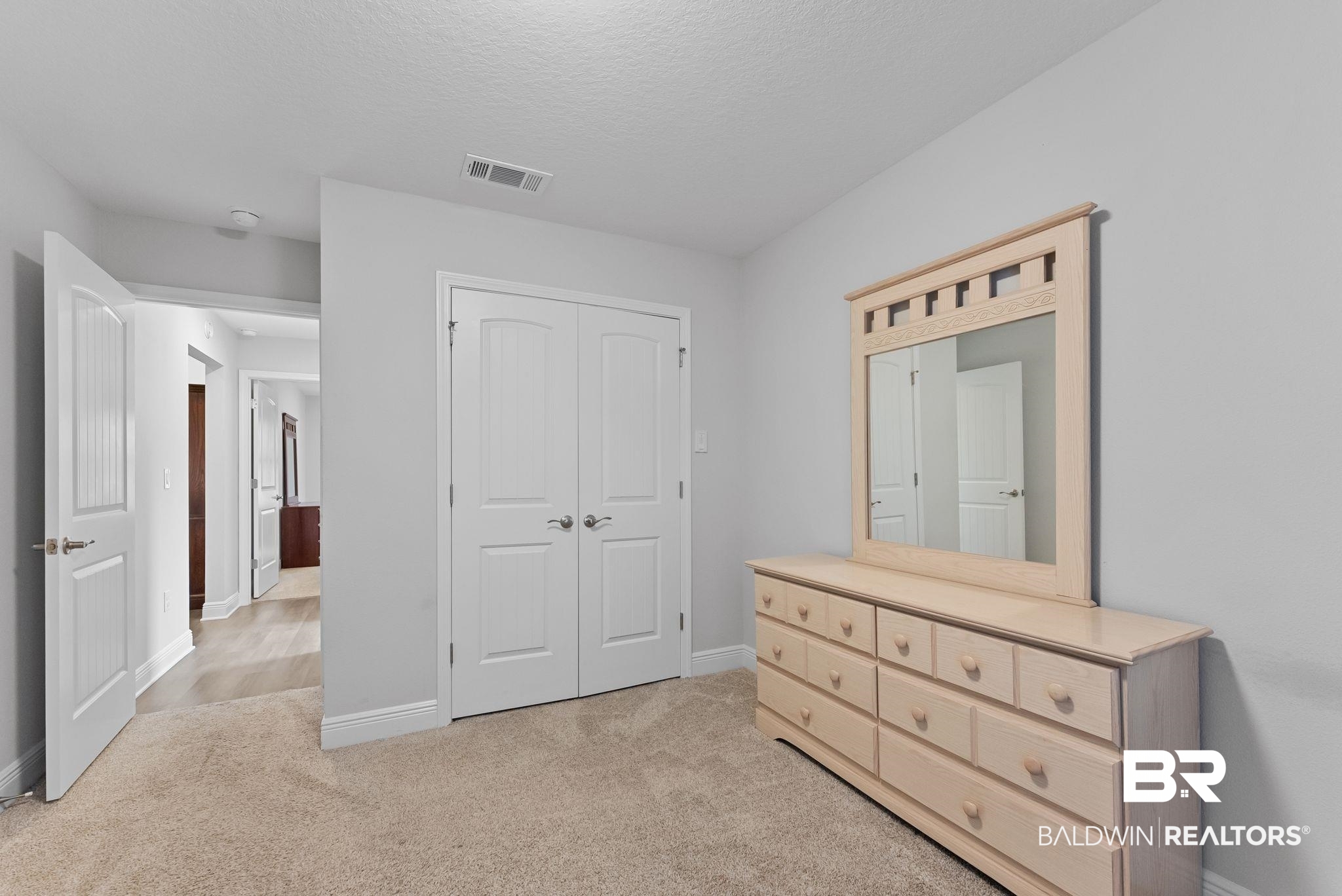 32868 Arbor Ridge Circle Lillian, AL 36549 - Photo 20 of 35 Bedroom with light colored carpet, a closet, and a textured ceiling
