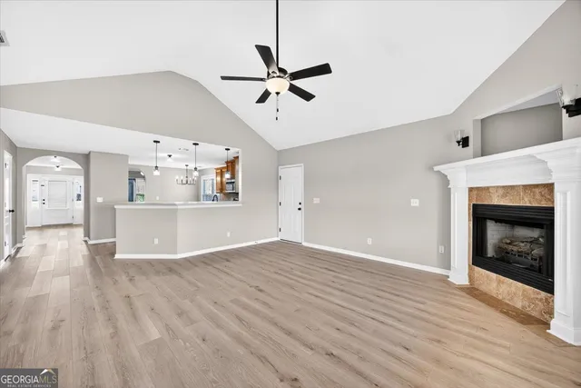 a view of a livingroom with a fireplace and wooden floor