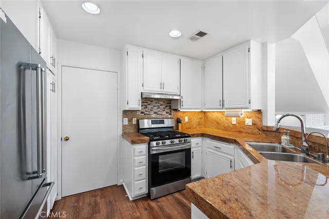 a kitchen with a sink stove and refrigerator