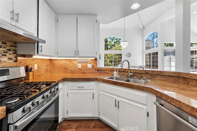 a kitchen with a sink stove and cabinets