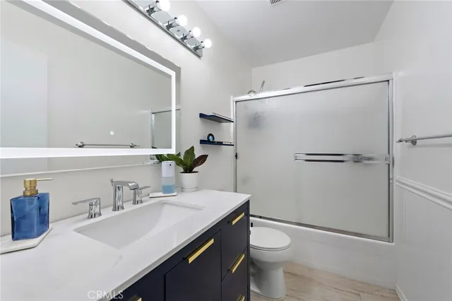 a bathroom with a sink toilet and mirror
