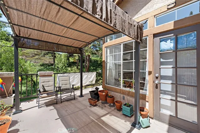 a glass door with couch and chairs