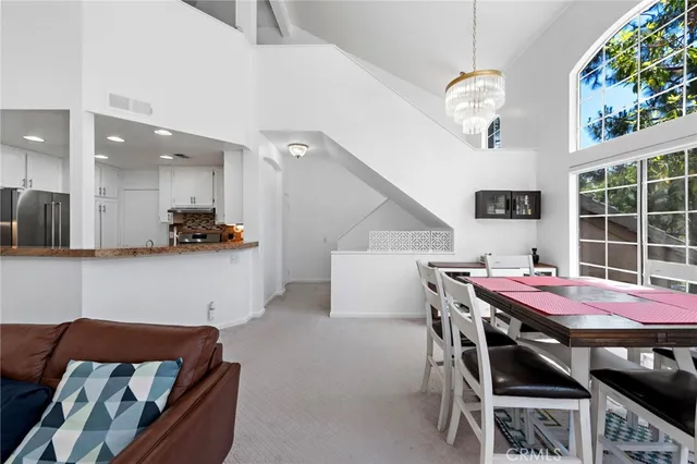 a dining room with furniture and a floor to ceiling window