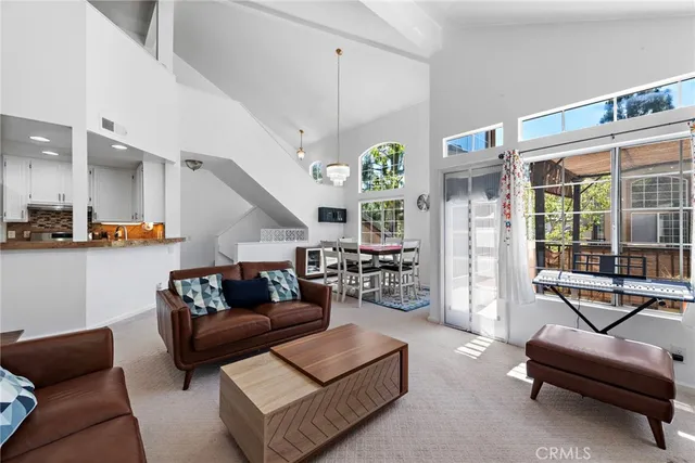 a living room with furniture and a floor to ceiling window