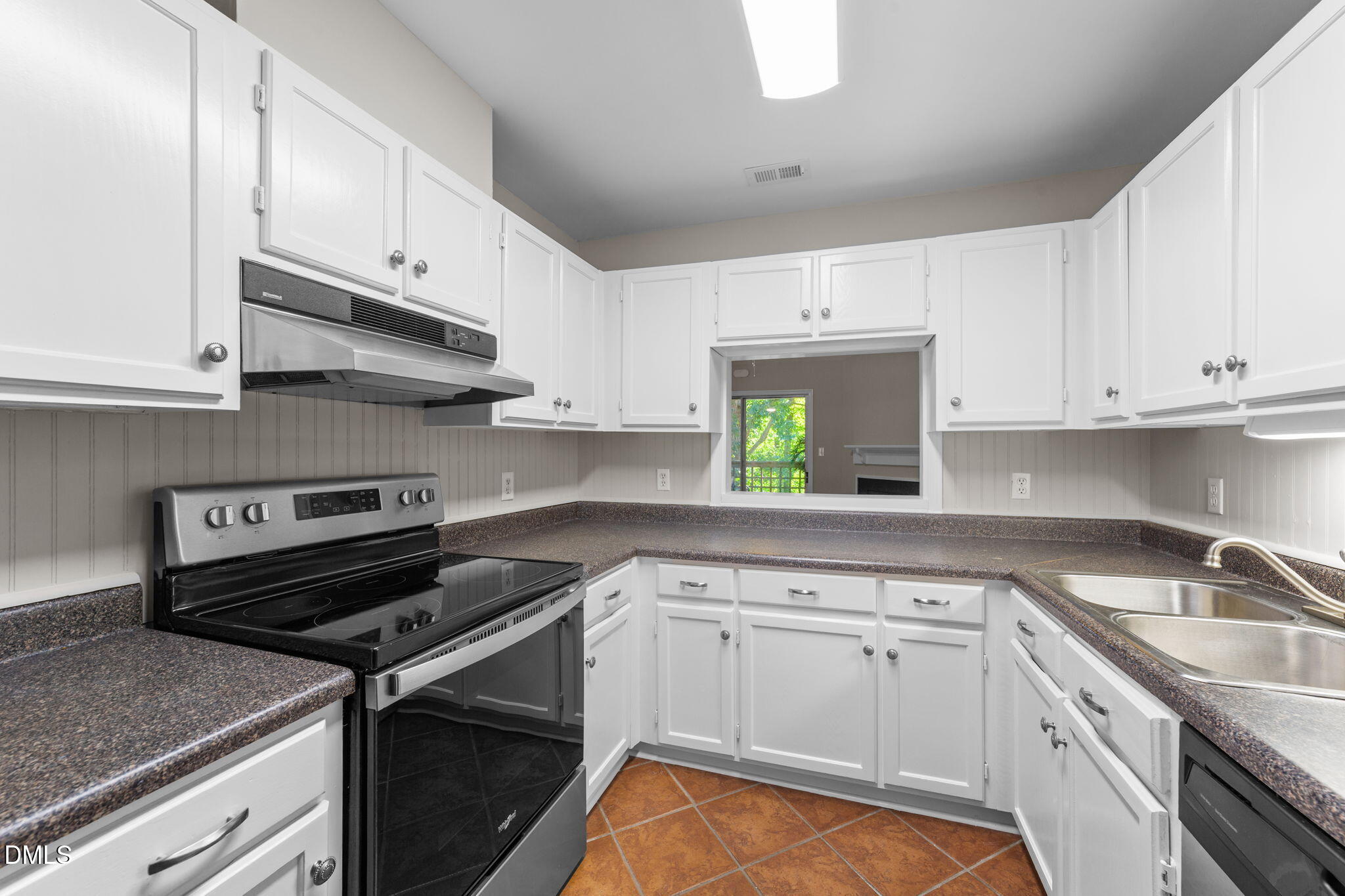 4110 Sedgewood Drive, Unit 302 Raleigh, NC 27612 - Photo 11 of 38 a kitchen with granite countertop a stove sink and cabinets