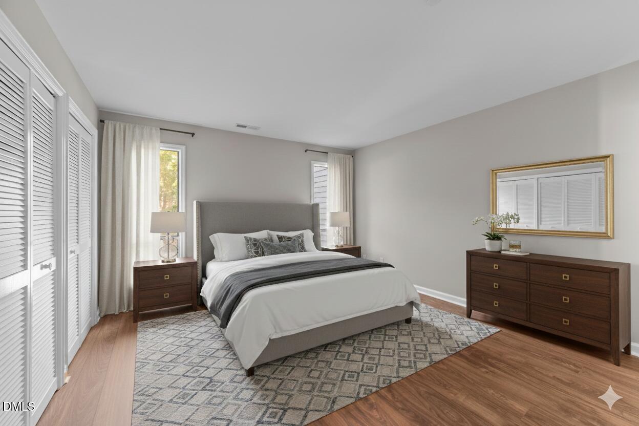 4110 Sedgewood Drive, Unit 302 Raleigh, NC 27612 - Photo 14 of 38 a bedroom with a bed and a dresser