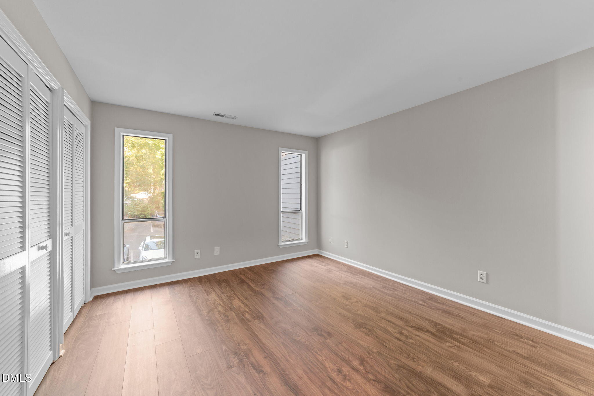 4110 Sedgewood Drive, Unit 302 Raleigh, NC 27612 - Photo 15 of 38 a view of an empty room with wooden floor and window