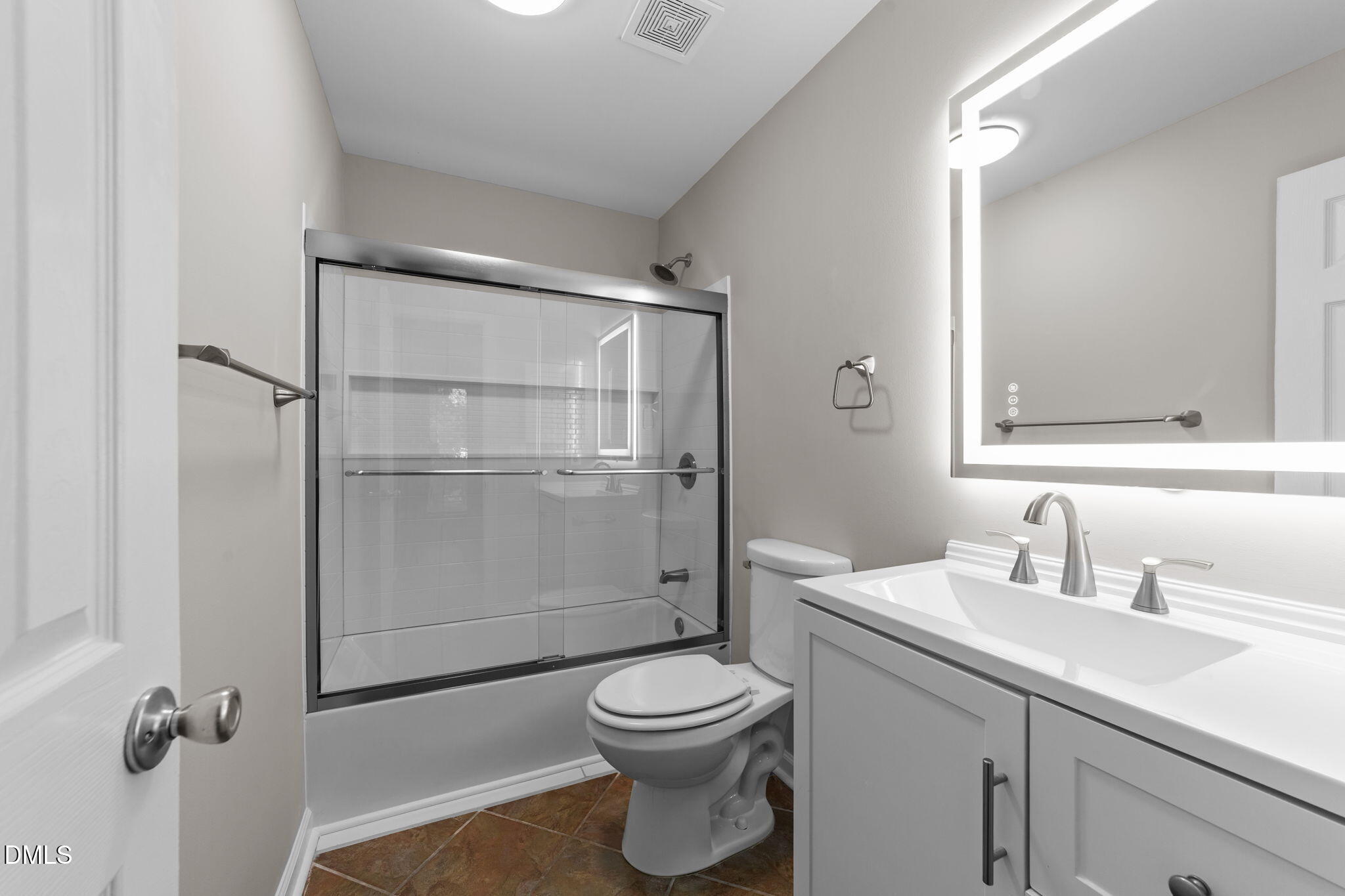 4110 Sedgewood Drive, Unit 302 Raleigh, NC 27612 - Photo 18 of 38 a bathroom with a toilet a sink and a mirror