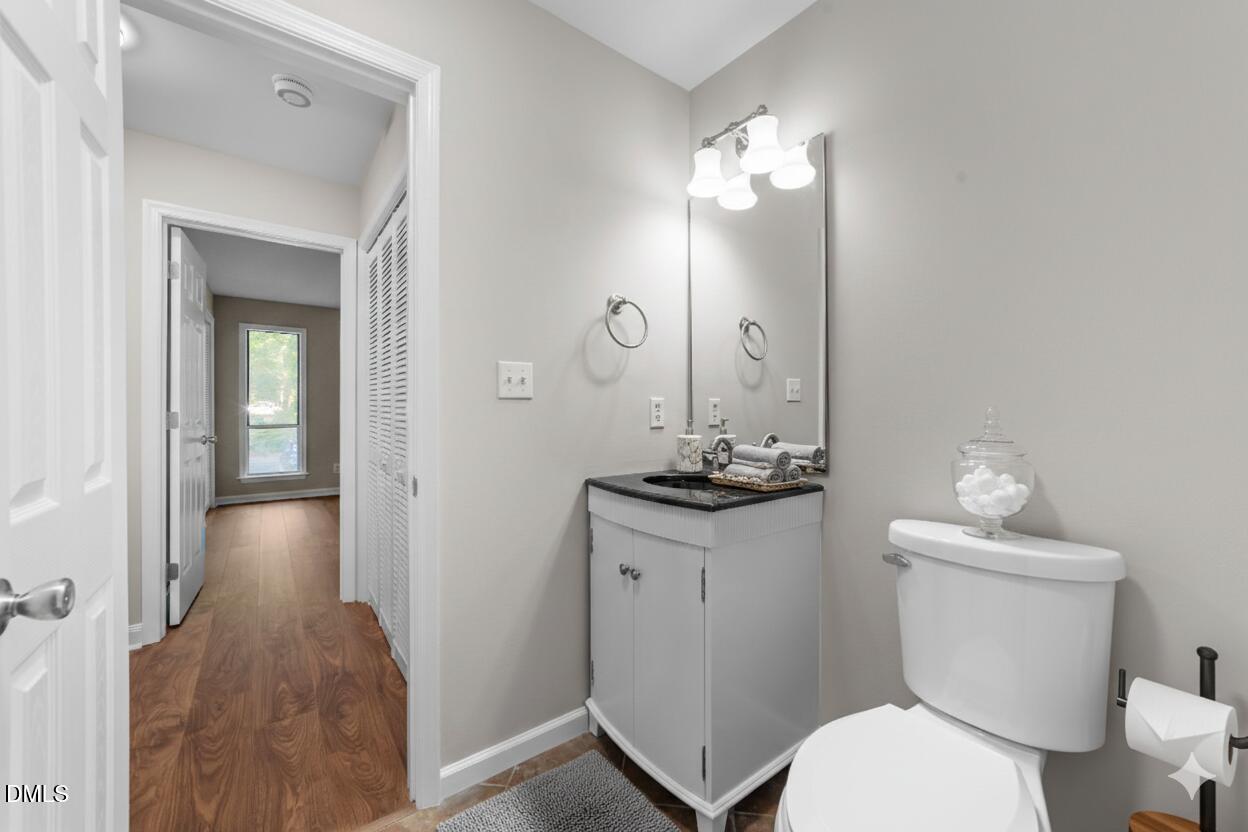 4110 Sedgewood Drive, Unit 302 Raleigh, NC 27612 - Photo 19 of 38 a bathroom with a toilet a sink and mirror