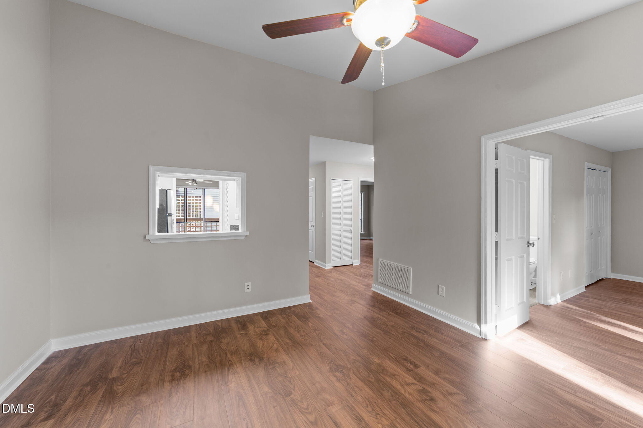 4110 Sedgewood Drive, Unit 302 Raleigh, NC 27612 - Photo 26 of 38 an empty room with wooden floor chandelier fan and windows