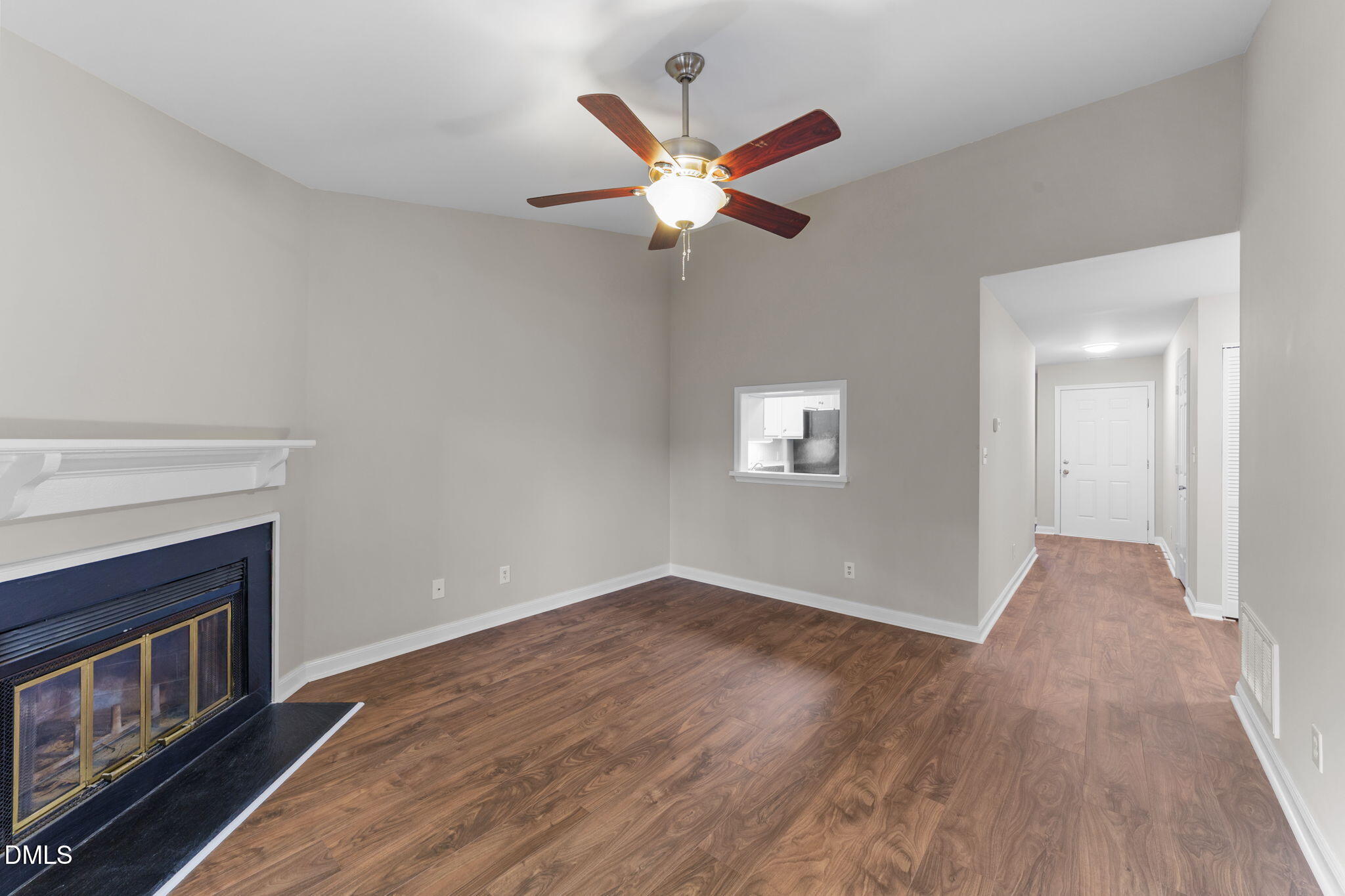4110 Sedgewood Drive, Unit 302 Raleigh, NC 27612 - Photo 28 of 38 a view of an empty room with wooden floor and a fireplace