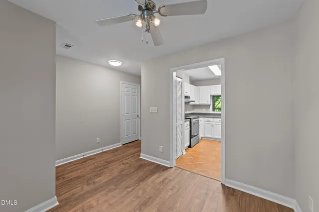 wooden floor in an empty room with a window