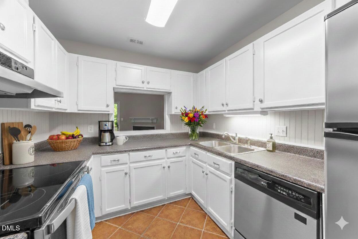 4110 Sedgewood Drive, Unit 302 Raleigh, NC 27612 - Photo 9 of 38 a kitchen with a sink cabinets and appliances