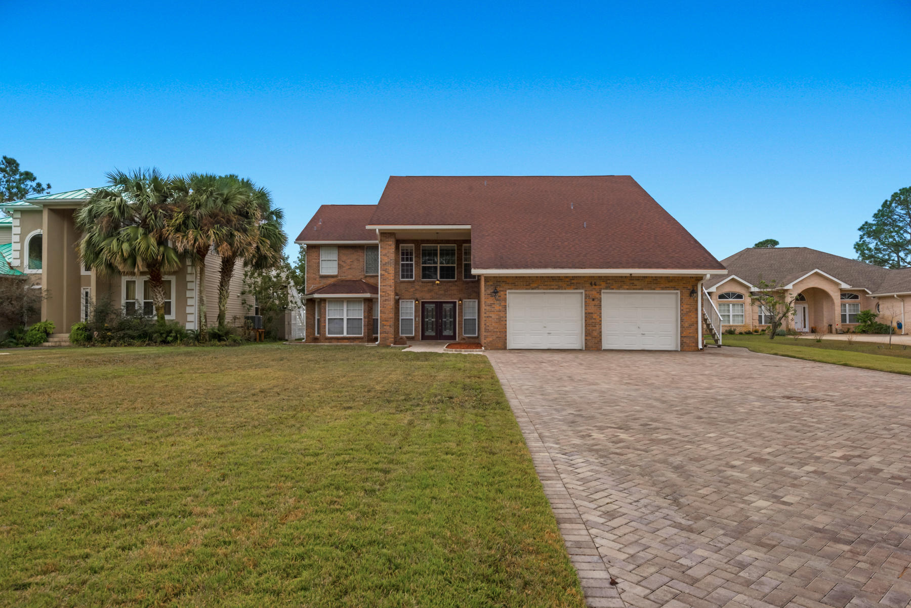 44 Dolphin Place Freeport, FL 32439 - Photo 1 of 76 a front view of a house with a garden