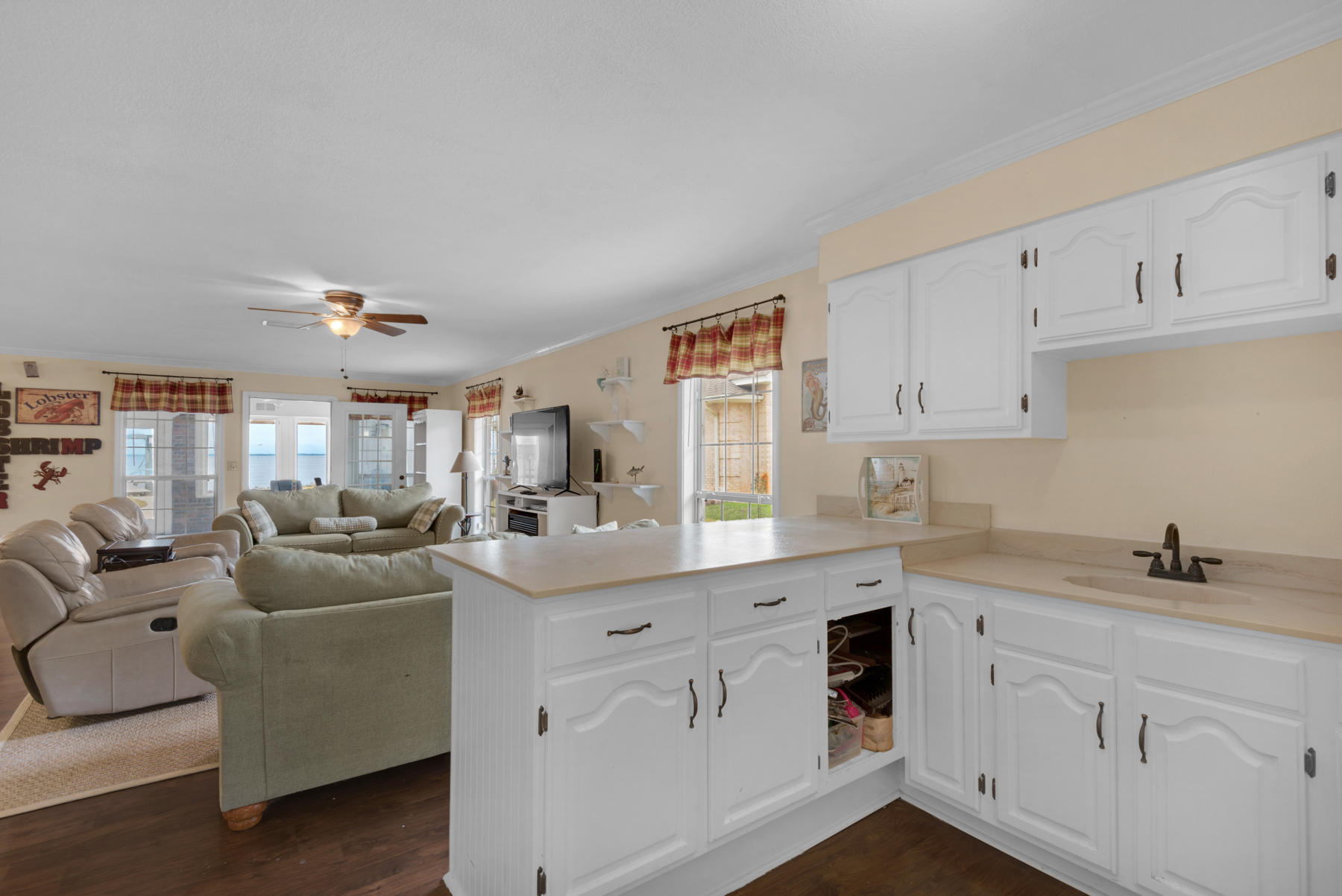 44 Dolphin Place Freeport, FL 32439 - Photo 18 of 76 a kitchen with white cabinets and white appliances