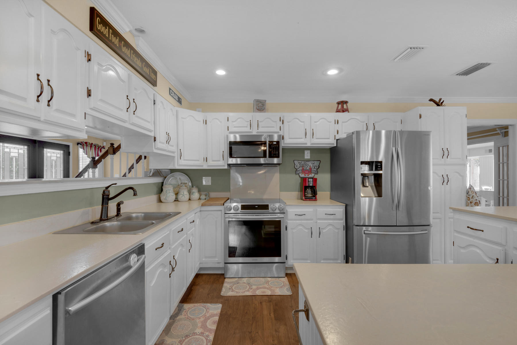 44 Dolphin Place Freeport, FL 32439 - Photo 22 of 76 a kitchen with stainless steel appliances granite countertop a refrigerator sink and white cabinets